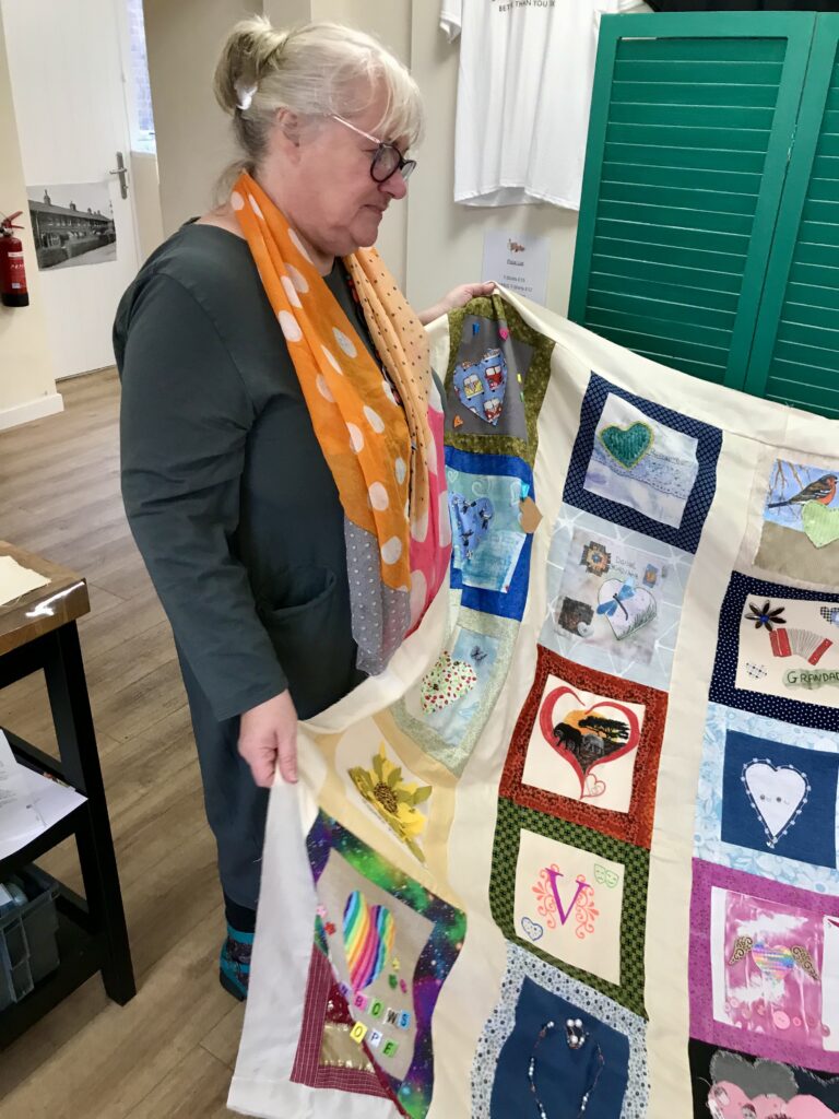 Caroline Aldridge, with one of the quilts